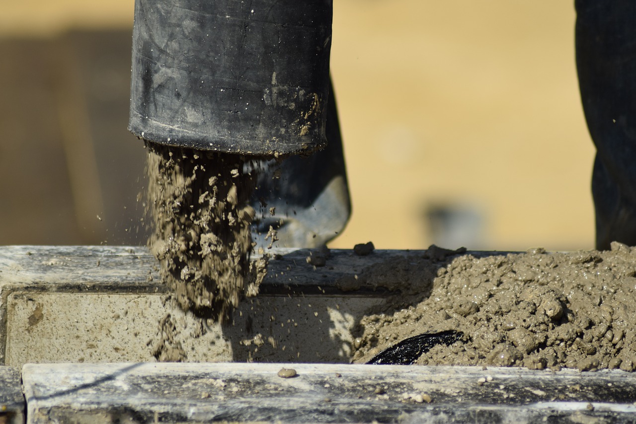 fresh concrete being poured from its container.
