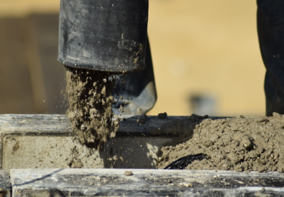 fresh concrete being poured from its container.