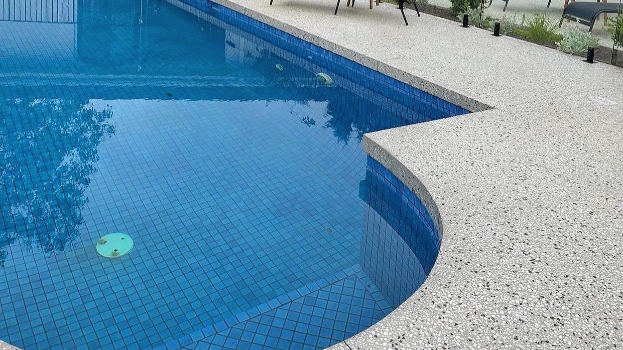 swimming pool with an exposed aggregate floor